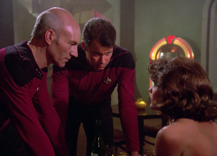 William T. Riker and Jean-Luc Picard talking with a woman