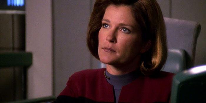 Captain Kathryn Janeway looking up