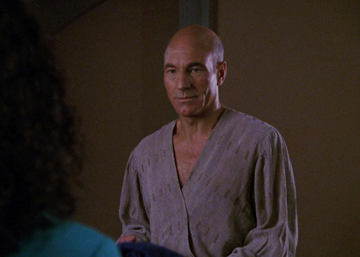 Jean-Luc Picard standing in a robe looking shirt
