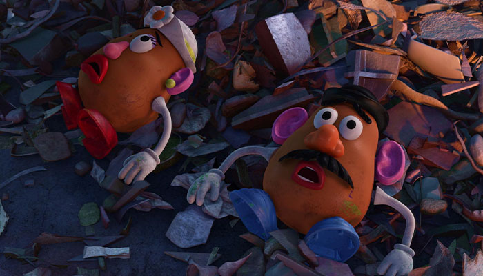 Mr. and Mrs potato head on top of a trash pile
