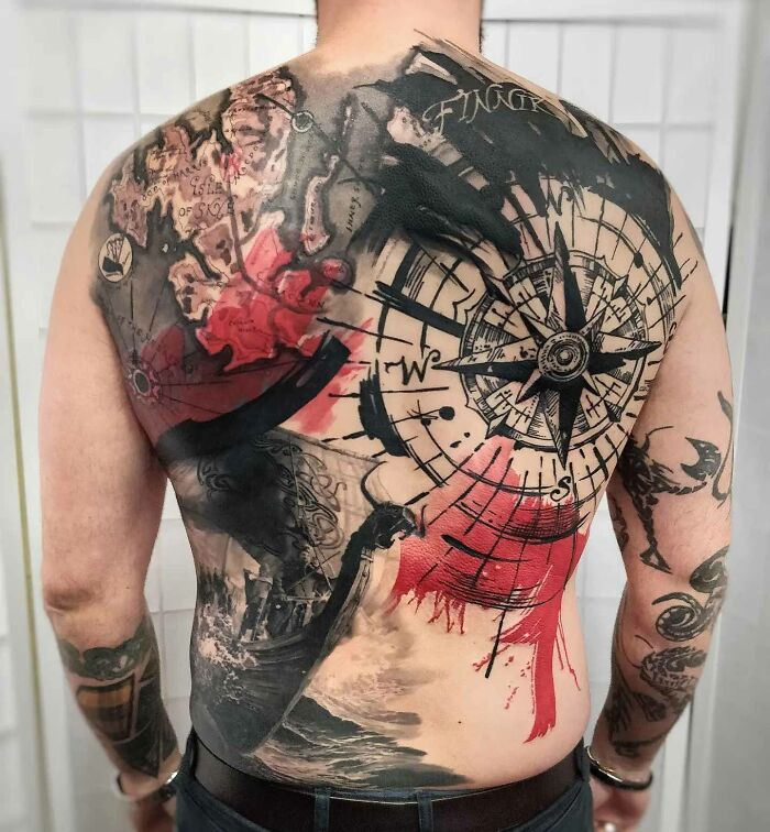 Trash Polka full back tattoo with compass and ship