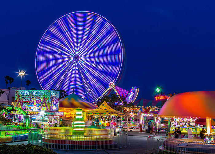 Colorful nighttime carnival scene with bright lights and spinning rides illustrating unique college courses creativity.