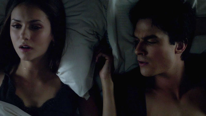 Elena and Damon lying in the bed 
