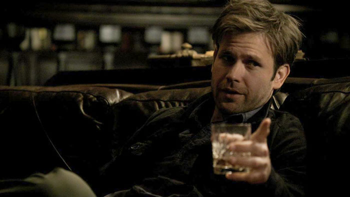 Alaric with a drink