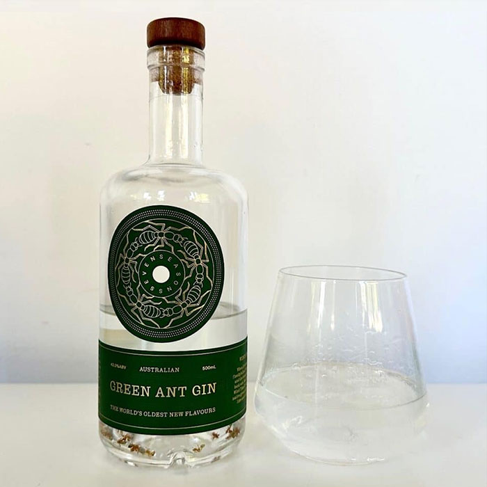 a bottle of gin with a glass nearby