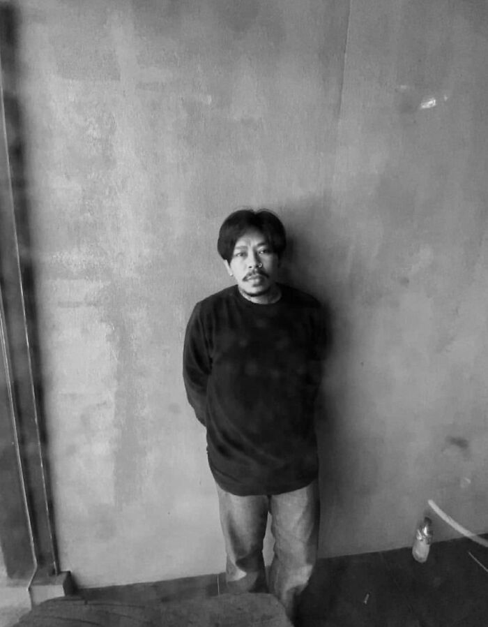 A tattoo artist in casual attire stands against a textured wall. Geometric tattoo style inspiration. A tattoo artist in casual attire stands against a textured wall. Geometric tattoo style inspiration.