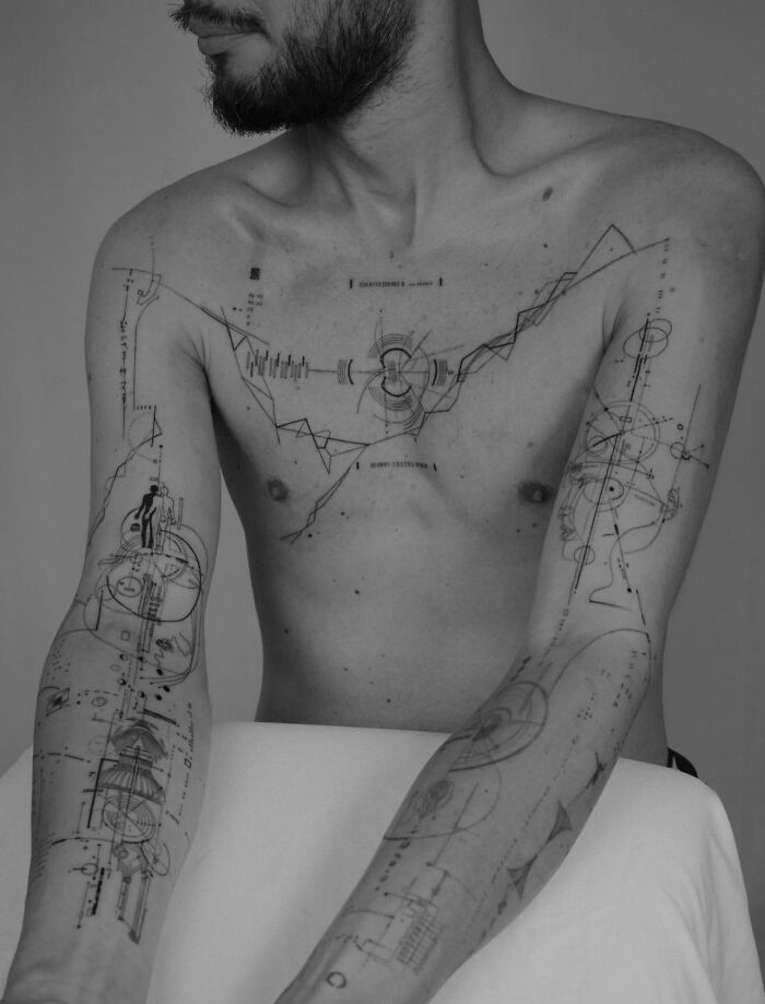 Man with geometric tattoos on chest and arms, featuring intricate patterns and lines in a minimalist black-and-white style. Man with geometric tattoos on chest and arms, featuring intricate patterns and lines in a minimalist black-and-white style.