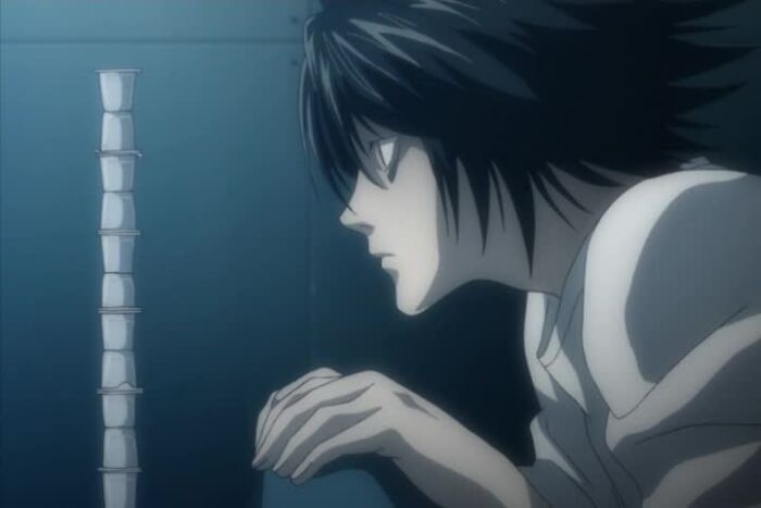 L sitting and looking from Death Note