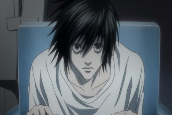 L sitting and watching from Death Note