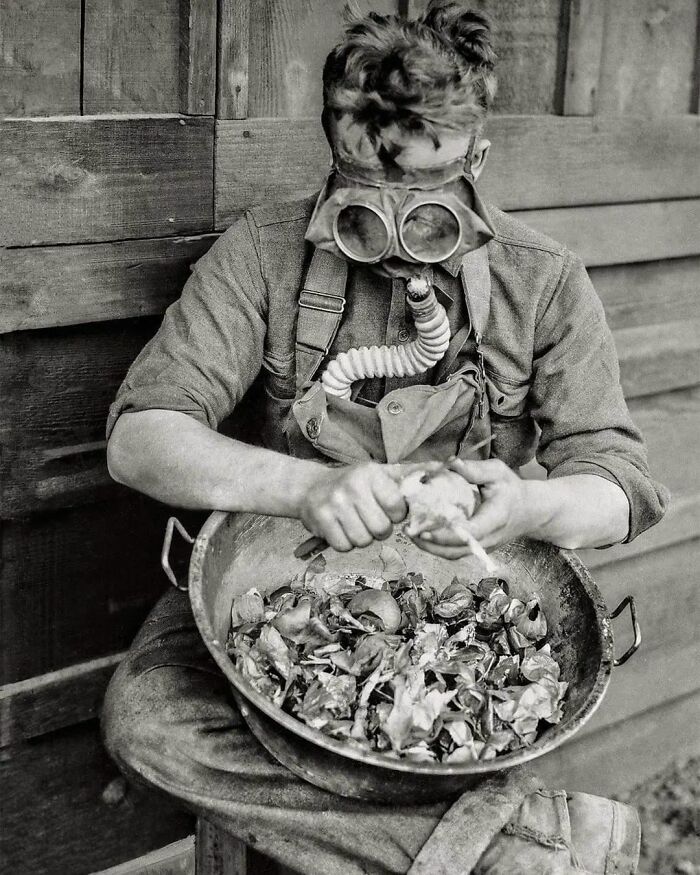 A Soldier Tests His Gas Mask While Peeling Onions. Camp Kearny, San Diego, USA, 1918. (World War One)