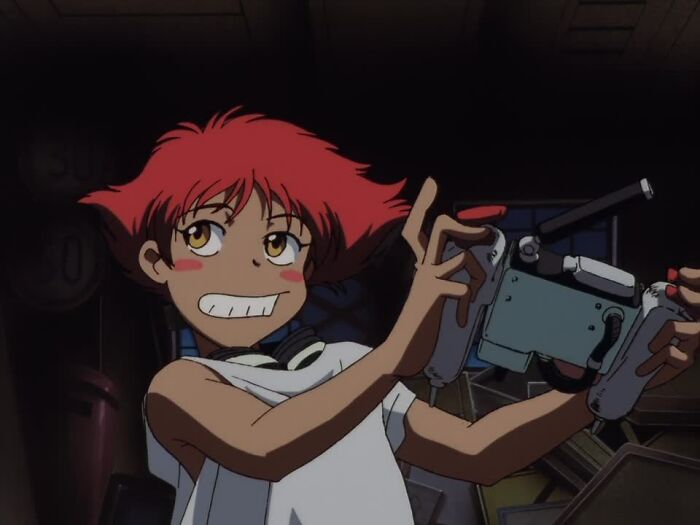 Ed holding controller and smiling from Cowboy Bebop