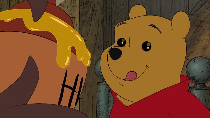 Winnie the Pooh looking at the pot of honey