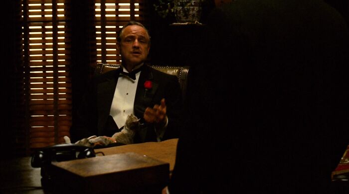 Don Vito Corleone talking and gesticulating 