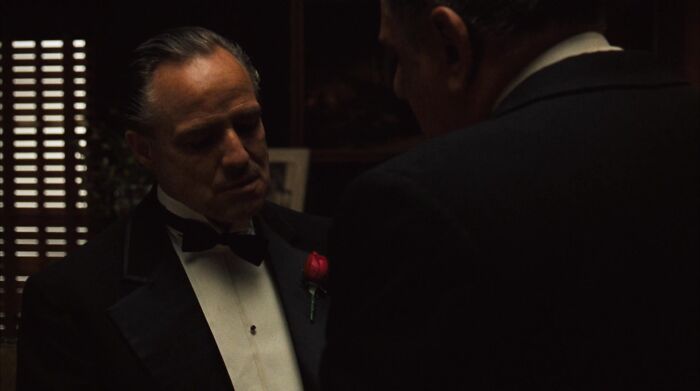 Don Vito Corleone talking with Luca Brasi