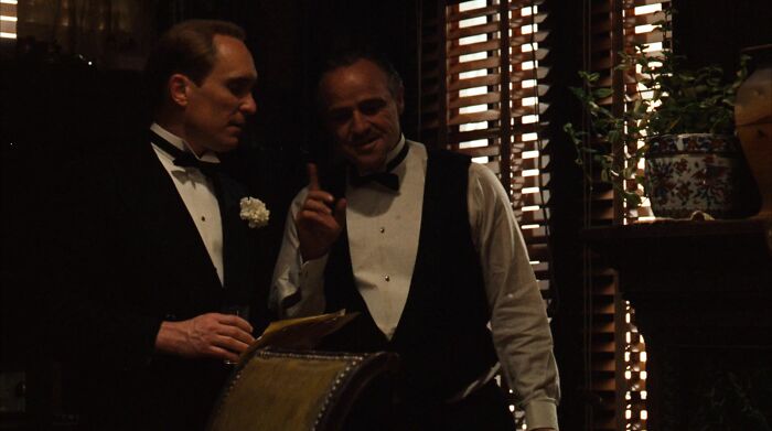 Don Vito Corleone talking and gesticulating 