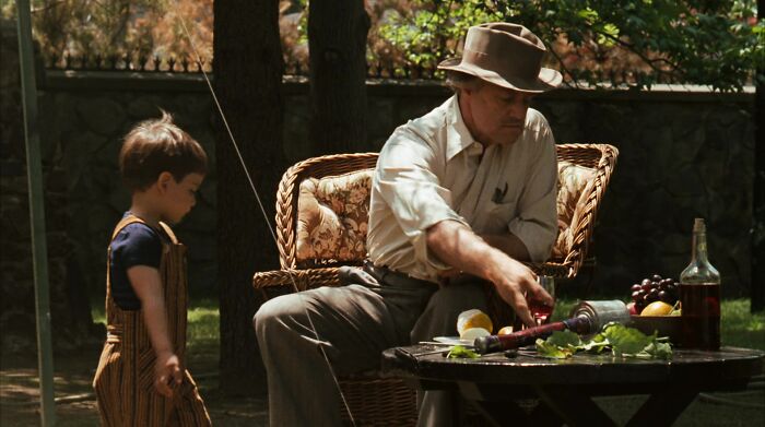 Don Vito Corleone sitting in a garden
