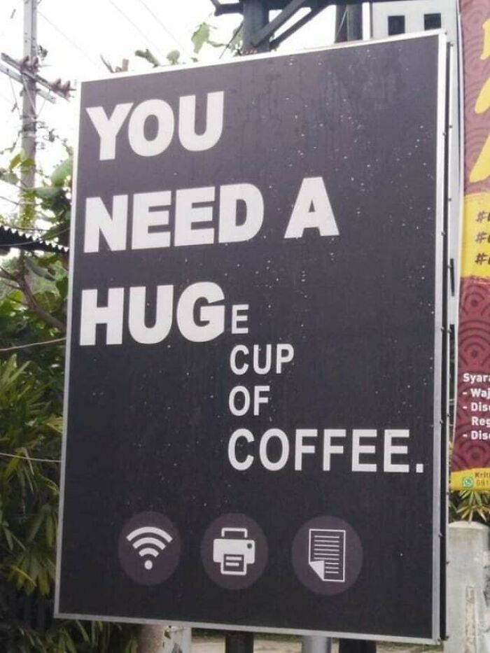 A coffee meme featuring a large black sign with white text. The sign reads, "YOU NEED A HUGe CUP OF COFFEE," with the word "HUG" in large letters, and the letter "e" in smaller font, making it look like the sign initially says "YOU NEED A HUG" before revealing the full message about needing a "huge cup of coffee." The meme humorously plays on the idea of needing comfort, with coffee being the ultimate remedy.