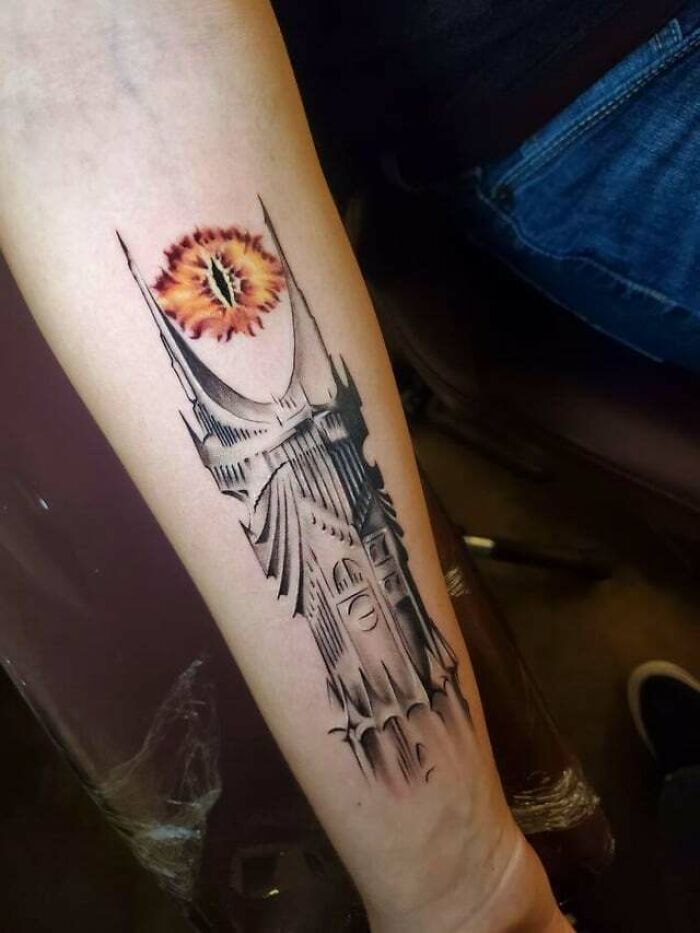 Arm tattoo of the Eye of Sauron and Barad-dûr tower, inspired by Lord of the Rings.