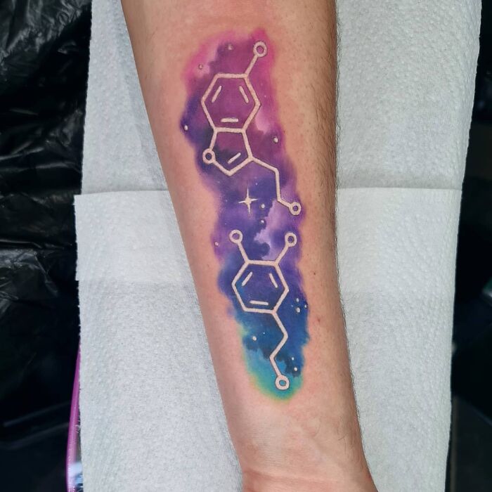 Serotonin and dopamine molecules on purple background tattoo