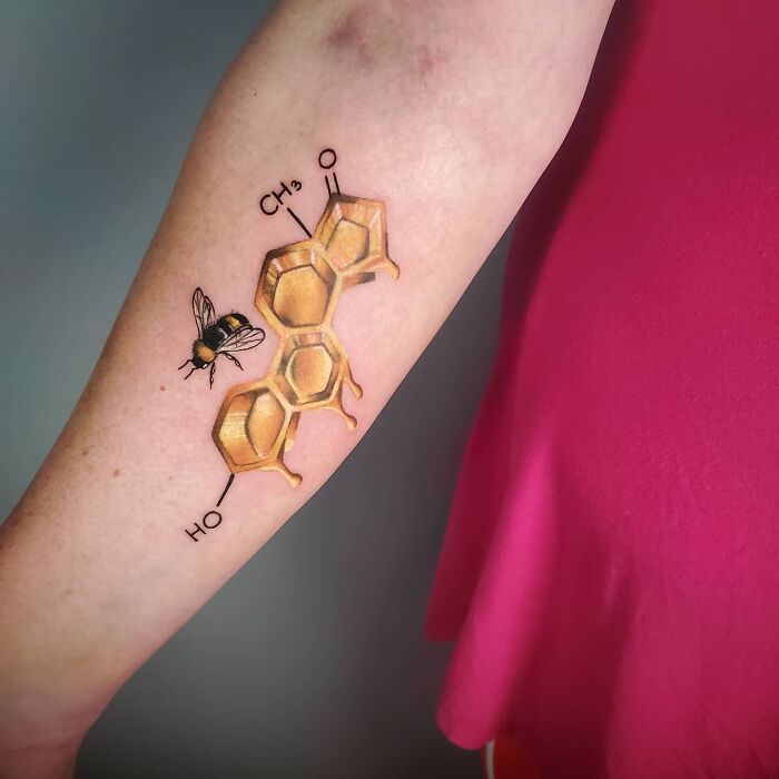 Golden honey comb bee arm tattoo