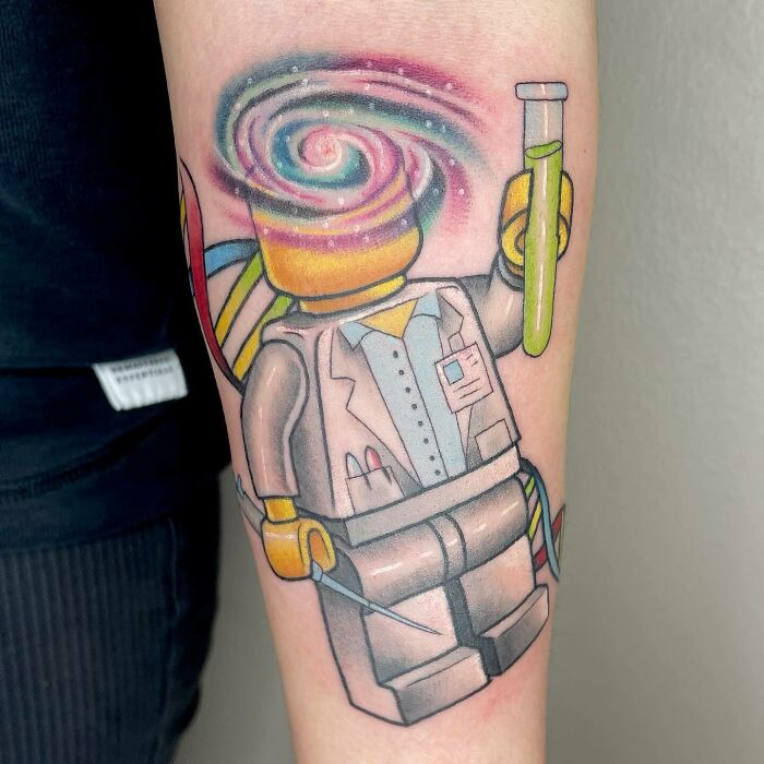 LEGO scientist with chemistry flask colorful arm tattoo