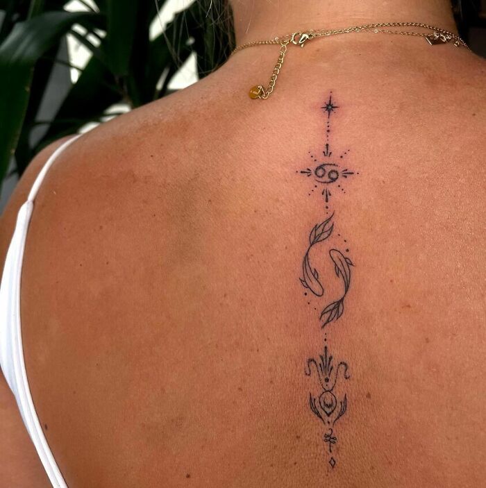 Zodiac ornament spine tattoo