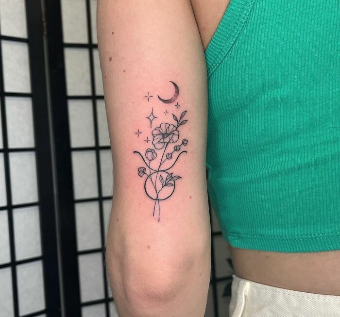 Taurus and flowers back of an arm tattoo
