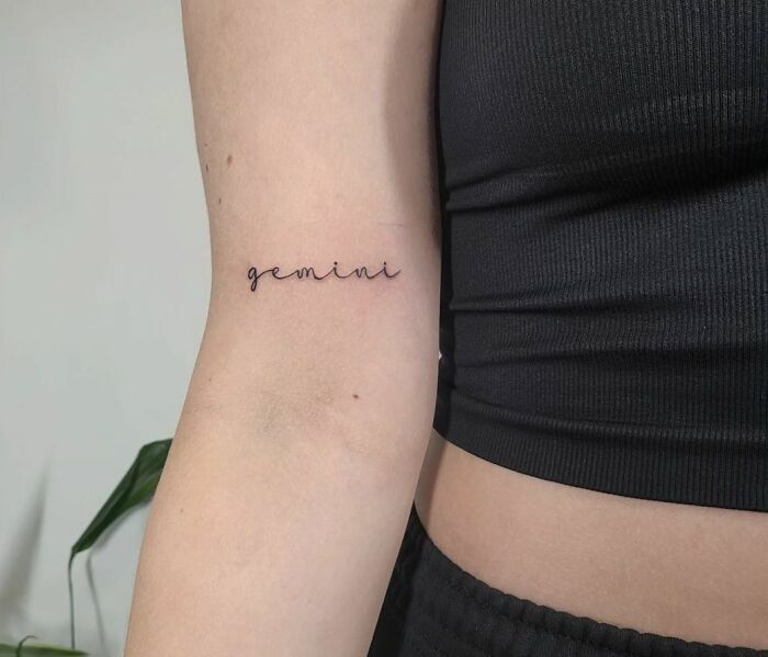 Gemini script arm tattoo