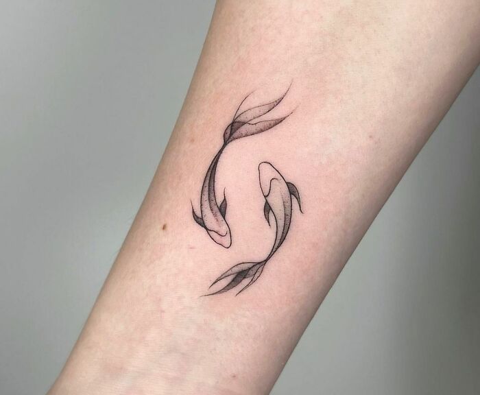 Fine line Pisces wrist tattoo