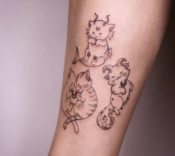 Cute zodiac tattoos featuring whimsical animal characters on an arm.