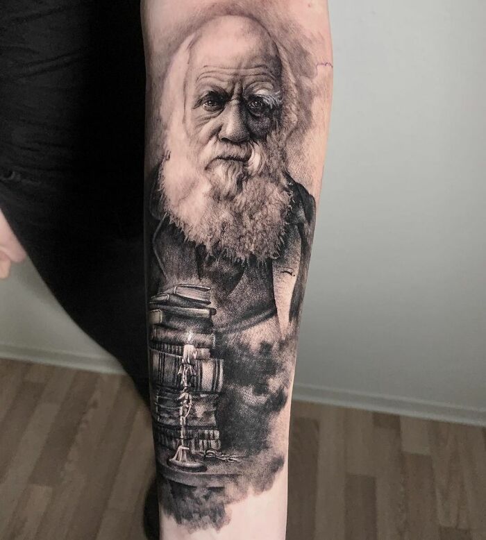 Realistic Charles Darwin portrait with books tattoo