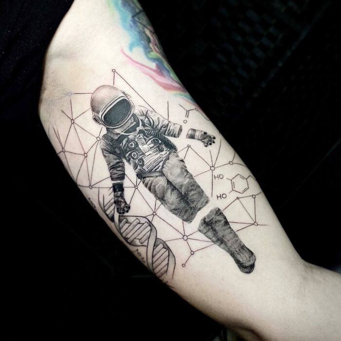 Astronaut, molecules and DNA tattoo on arm