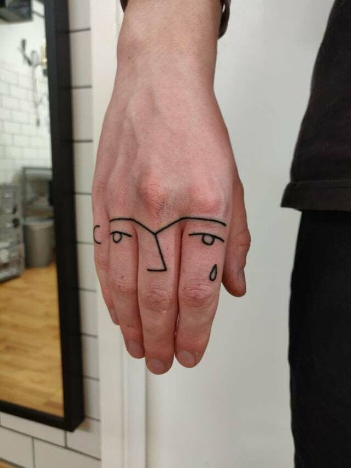 An Abstract finger Face Tattoo