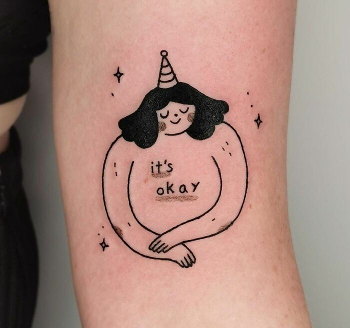 "It's Okay" inscription next to a illustration of a woman tattoo