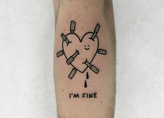 Heart with knifes in it and "I'm fine" inscription tattoo