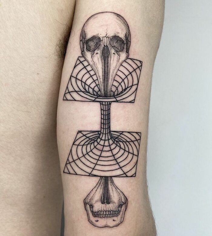 Skull going through a wormhole tattoo on arm