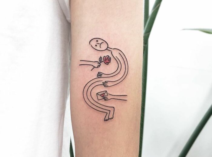 Sad human posture whom hands giving flower and letter tattoo
