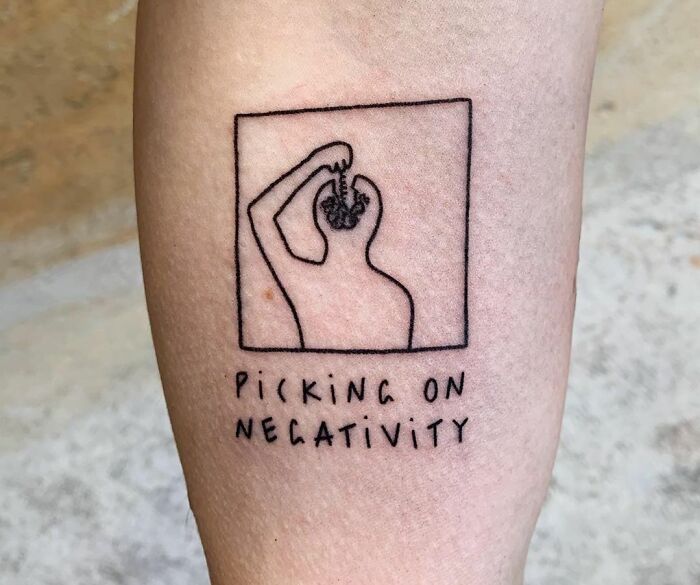 "Picking On Negativity'" with human posture digging his mind tattoo