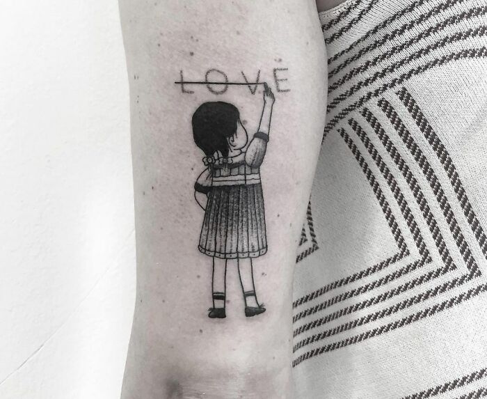 Girl crossing word "Love" tattoo 