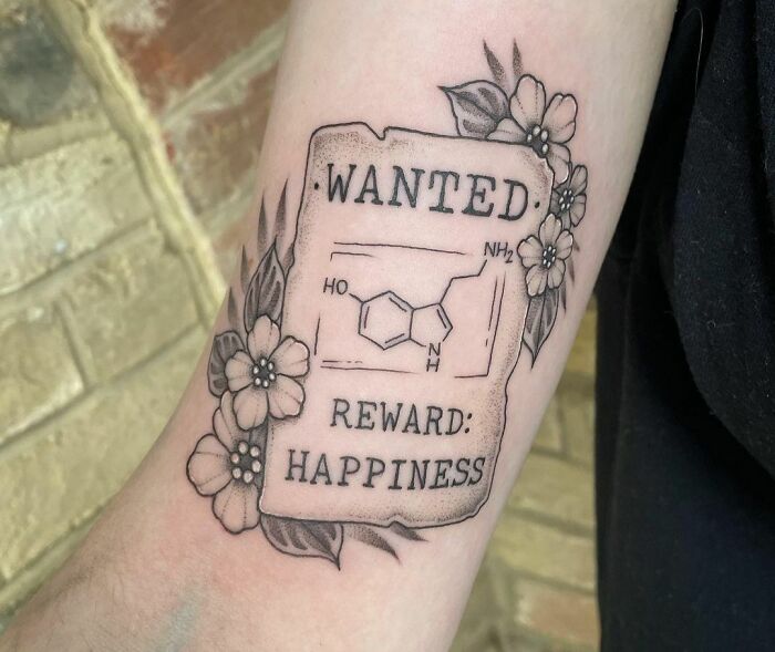 "Wanted Serotonin Reward: Happiness" with flowers tattoo