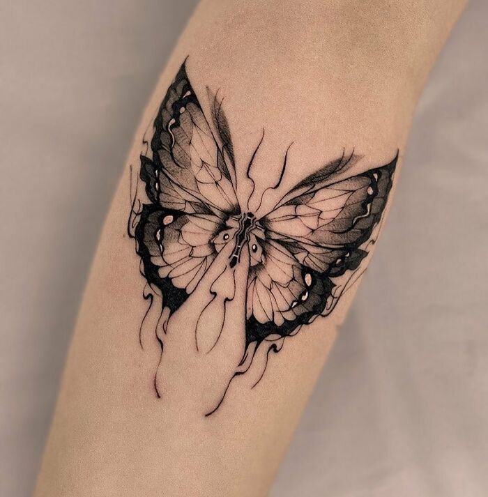 abstract butterfly arm tattoo