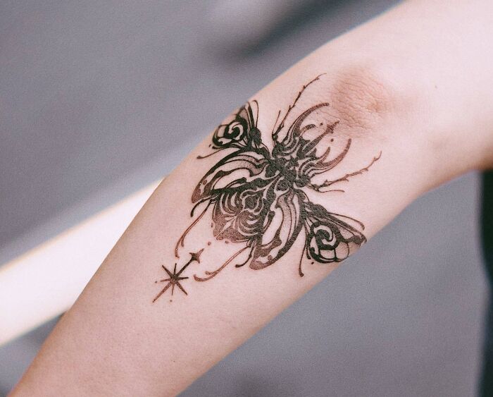 abstract Butterfly combined with a beetle elbow Tattoo