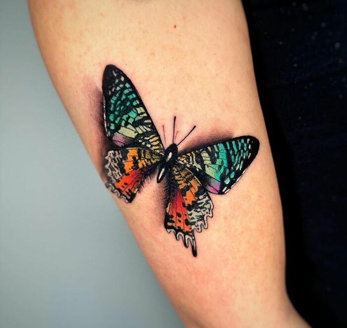Colorful large butterfly arm tattoo