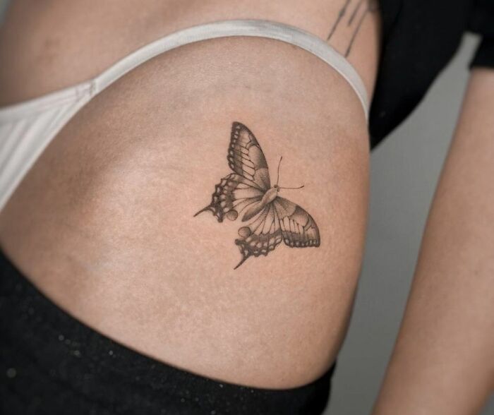 abstract butterfly hip tattoo