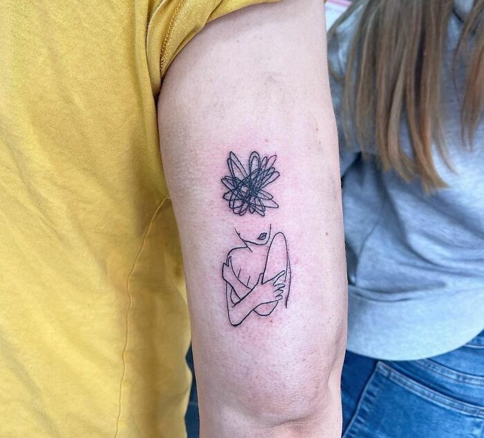 Woman hugging herself with confused thoughts tattoo 