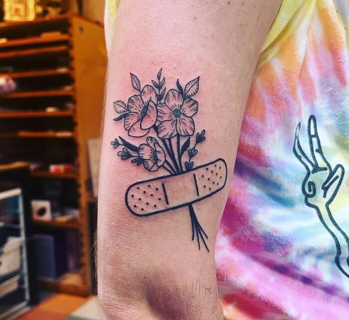 Flowers with patch arm tattoo 