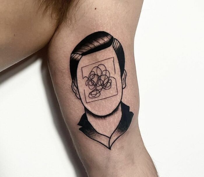 Human face with tangled lines tattoo 