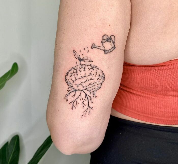 Brain with plants growing from it tattoo 