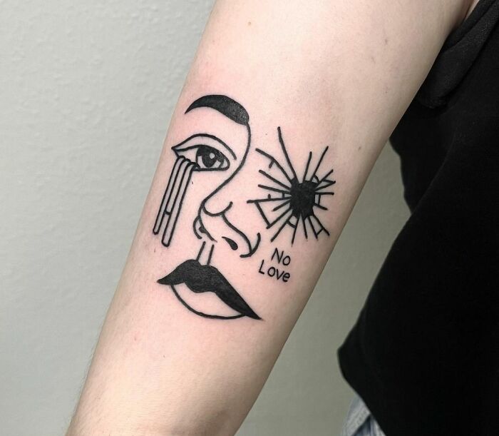 Crying and broken face with "No love" inscription tattoo
