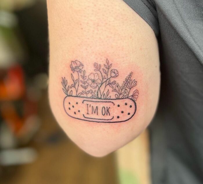 "I'm Ok" patch with flowers arm tattoo 